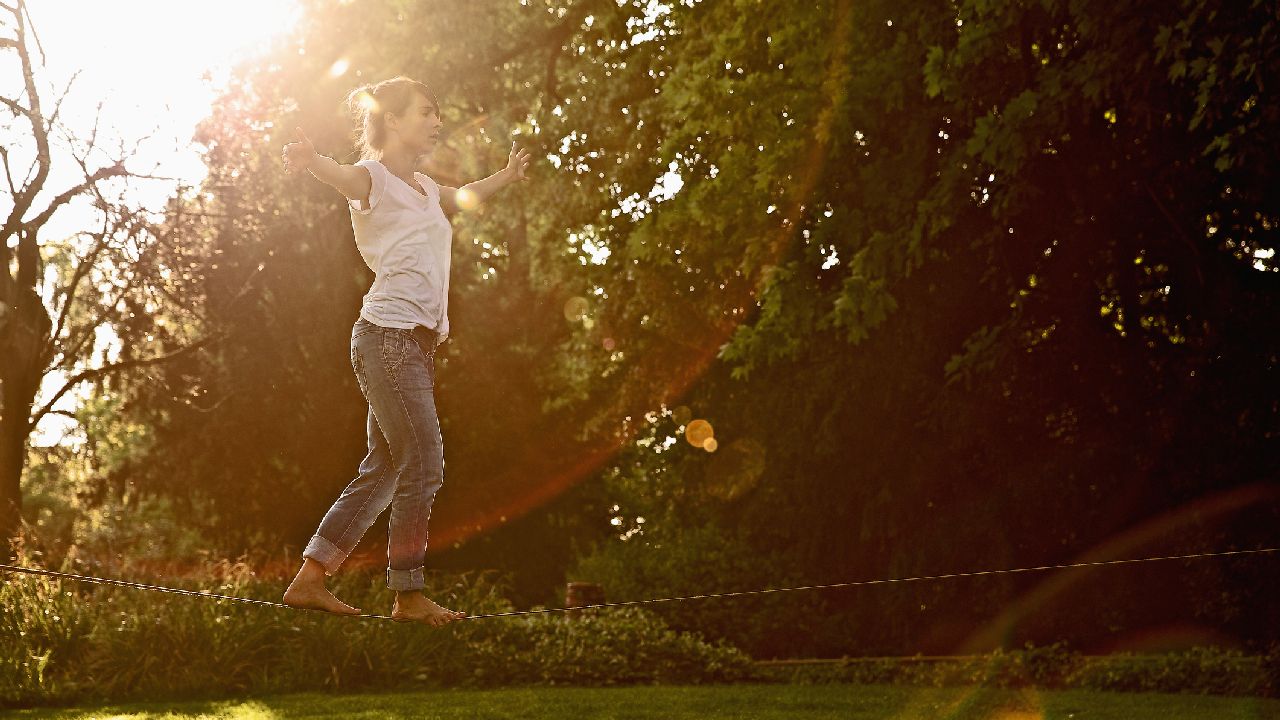 Kötélen egyensúlyozó lány