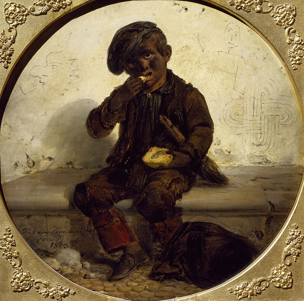 Apró kéményseprő inas eszik.