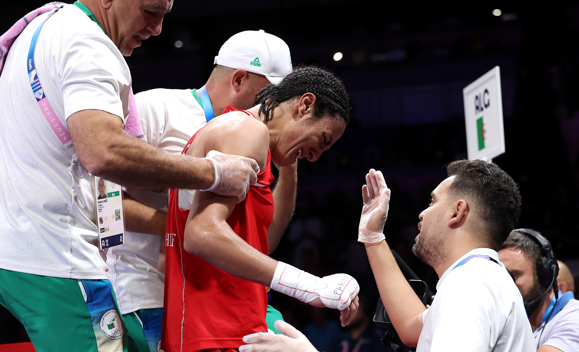 PARIS, FRANCE - AUGUST 03: Imane Khelif of Team Algeria is assisted out of the ring by Mohamed Al-Shawa, Coach of Team Hungary after the Women's 66kg Quarter-final round match on day eight of the Olympic Games Paris 2024 at North Paris Arena on August 03, 2024 in Paris, France. (Photo by Richard Pelham/Getty Images)