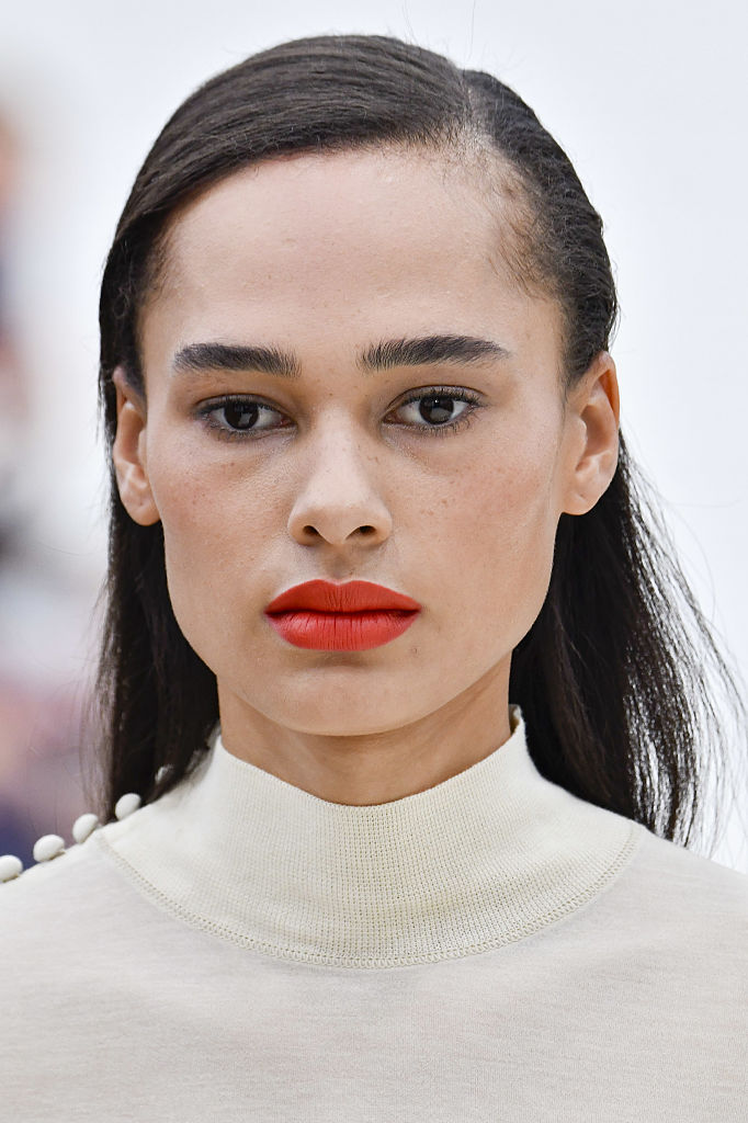 Élénk színű rúzst viselő modell a kifutón