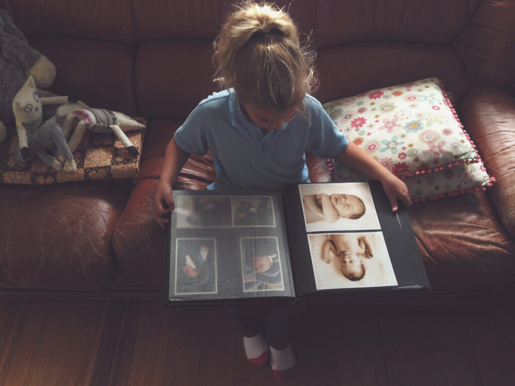 Kislány családi képeket nézeget