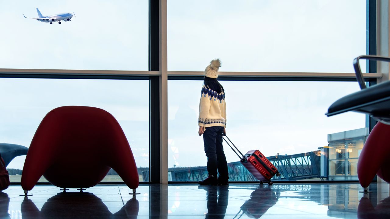 Lány várakozik a reptéren sapkában