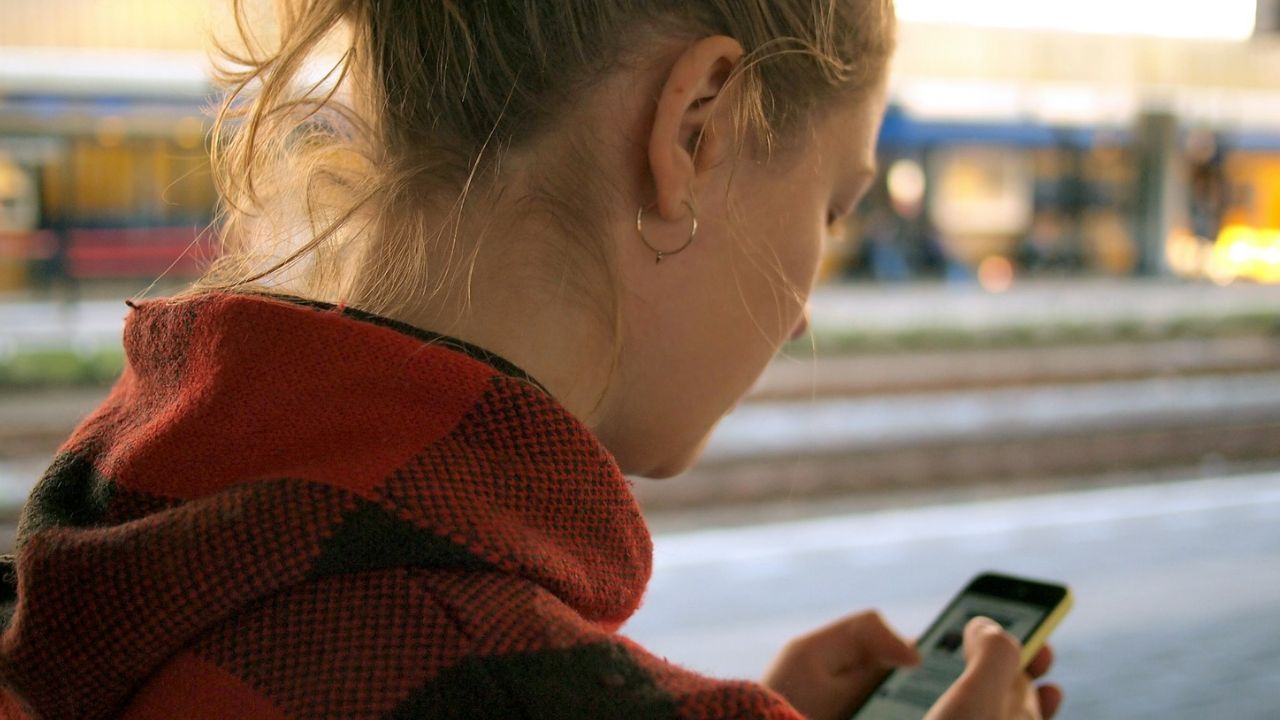 nő a telefonjával, fotó: Unsplash