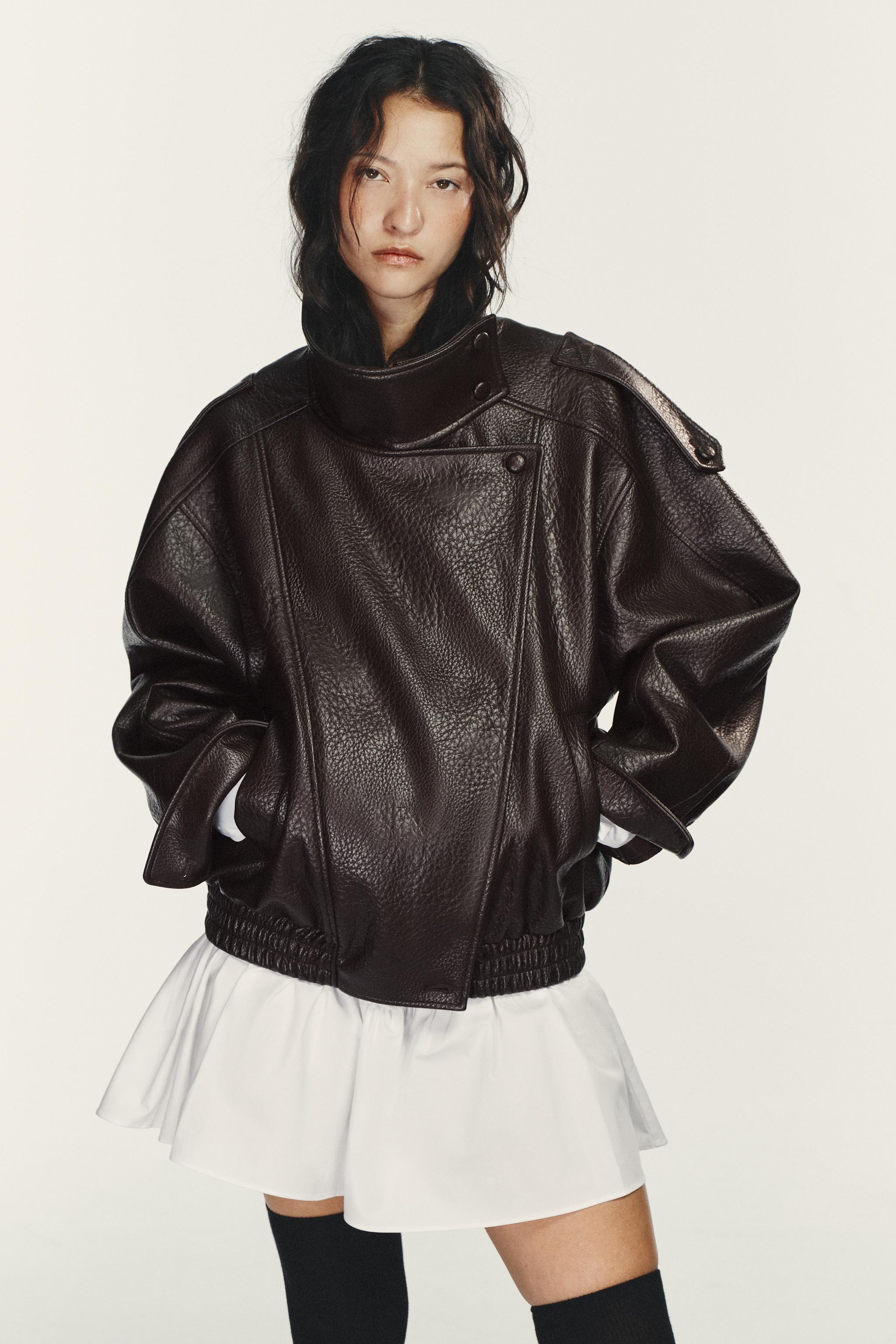 Tölcsérnyakú bőrdzsekit viselő modell